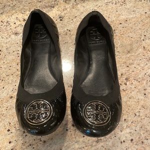 Tory Burch size 7.5 black ballet flats with black and gold emblem.